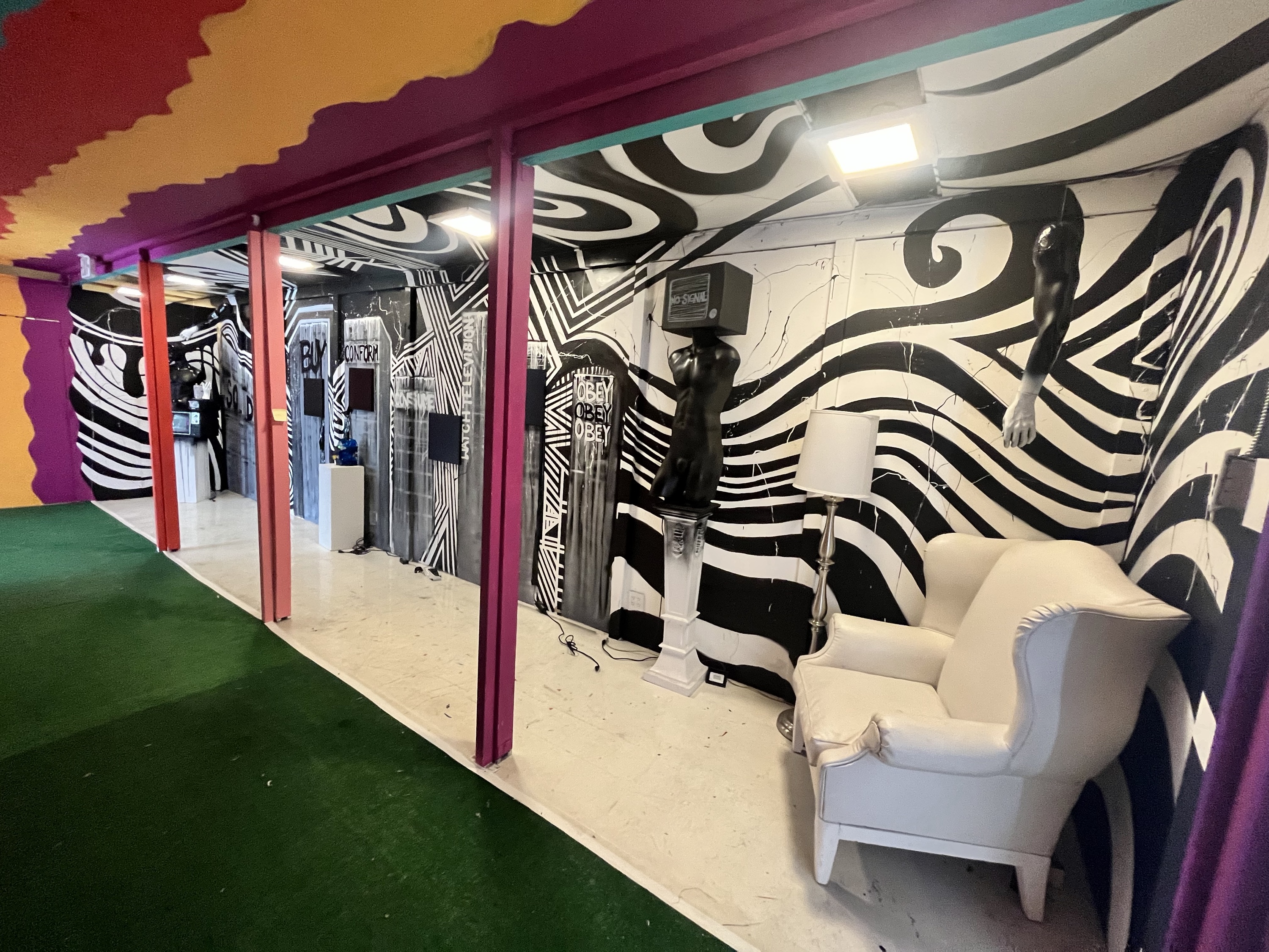 Pew Pew Presents immersive art installation in Miami with black and white op-art walls and a colourful ceiling