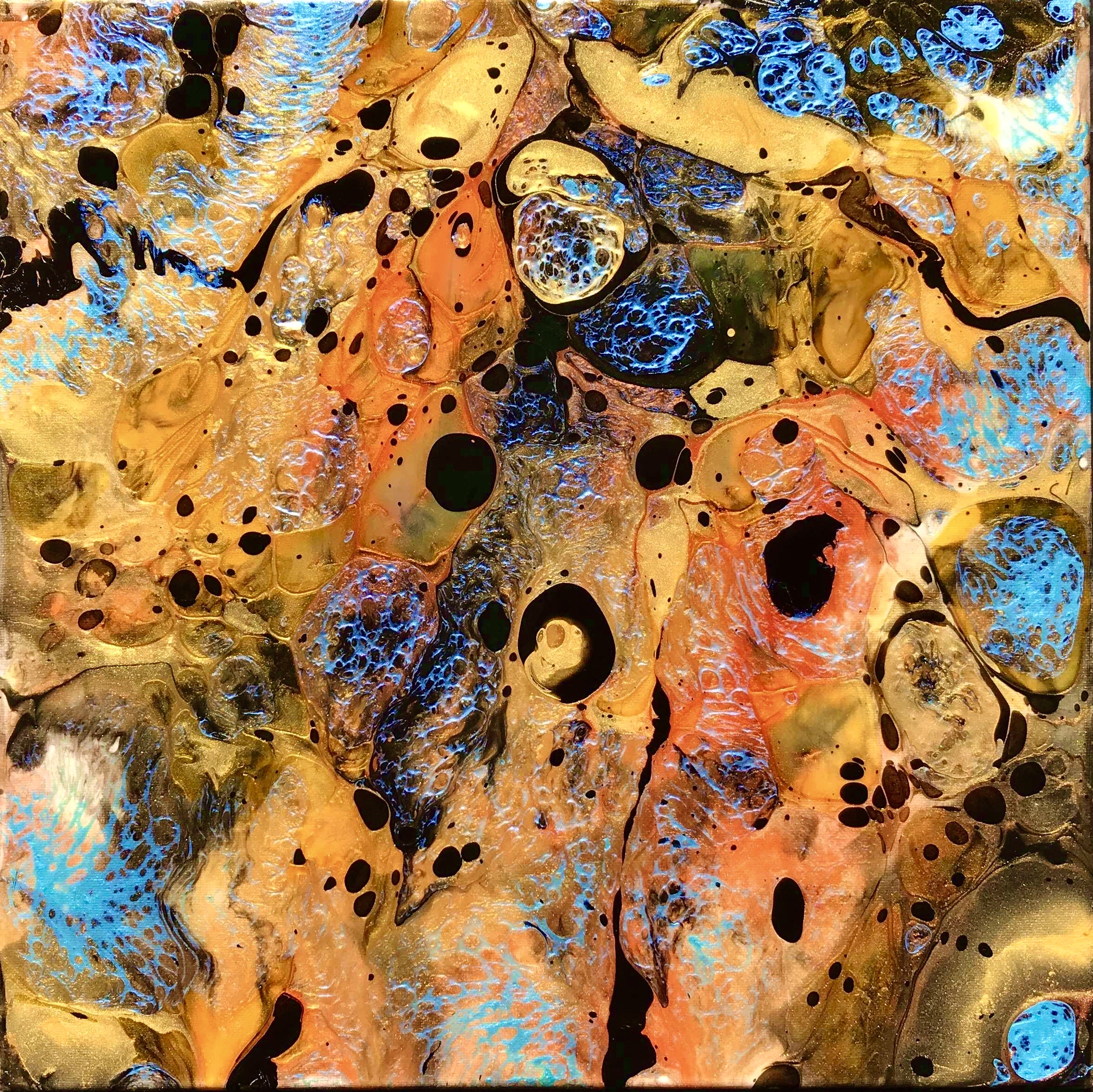 Resin pour with amber, gold and blue cells