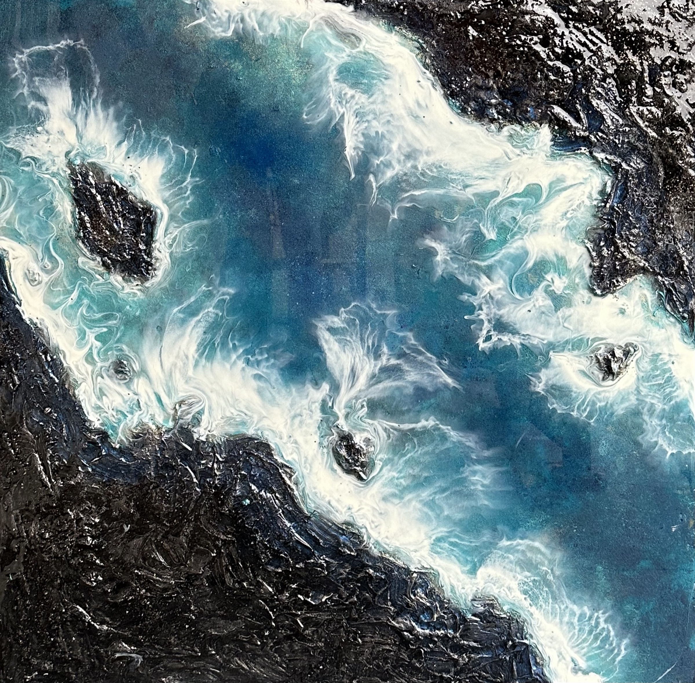 Ocean resin artwork with white surf breaking on a black textured coast