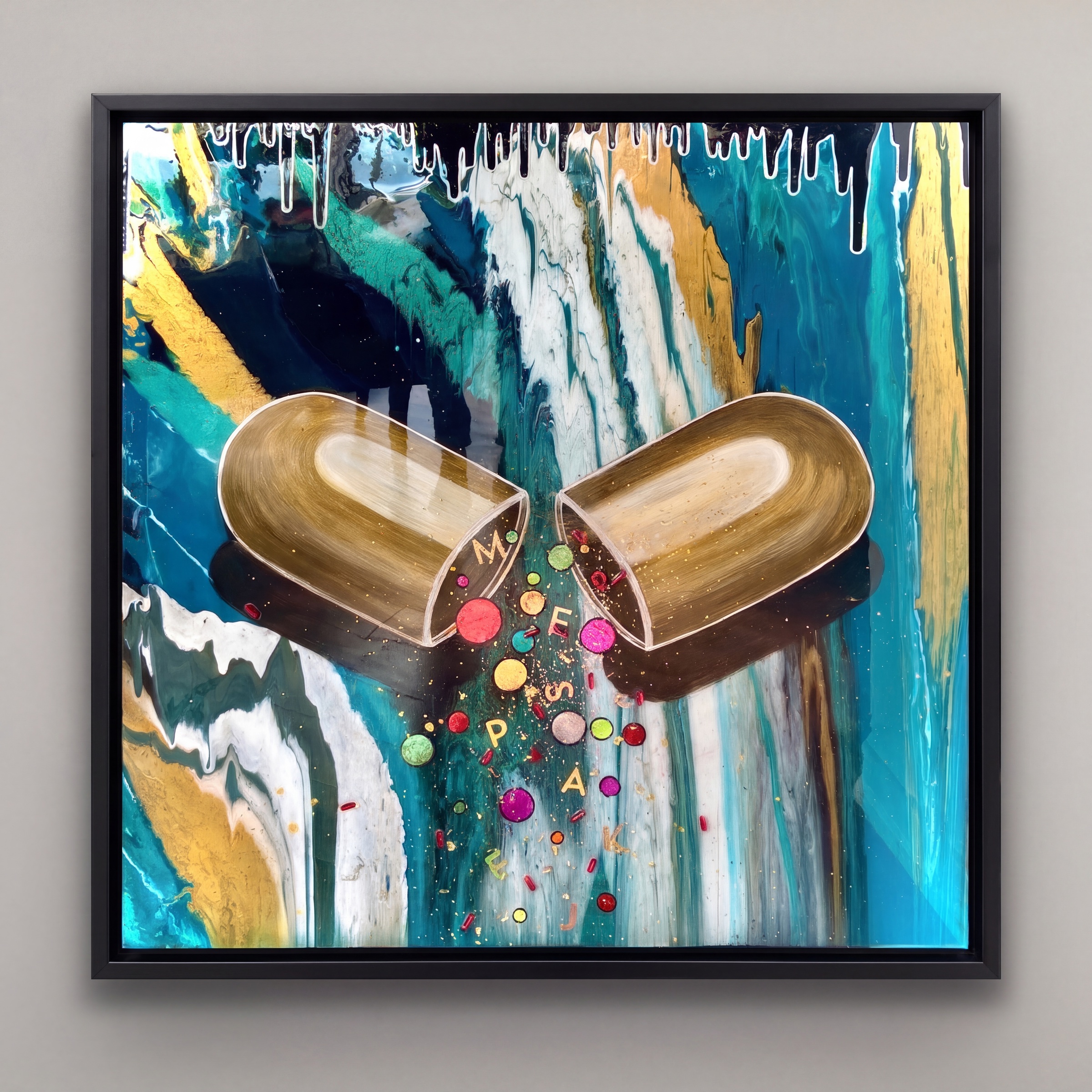 Framed resin artwork with two golden capsules splitting open over teal and gold resin