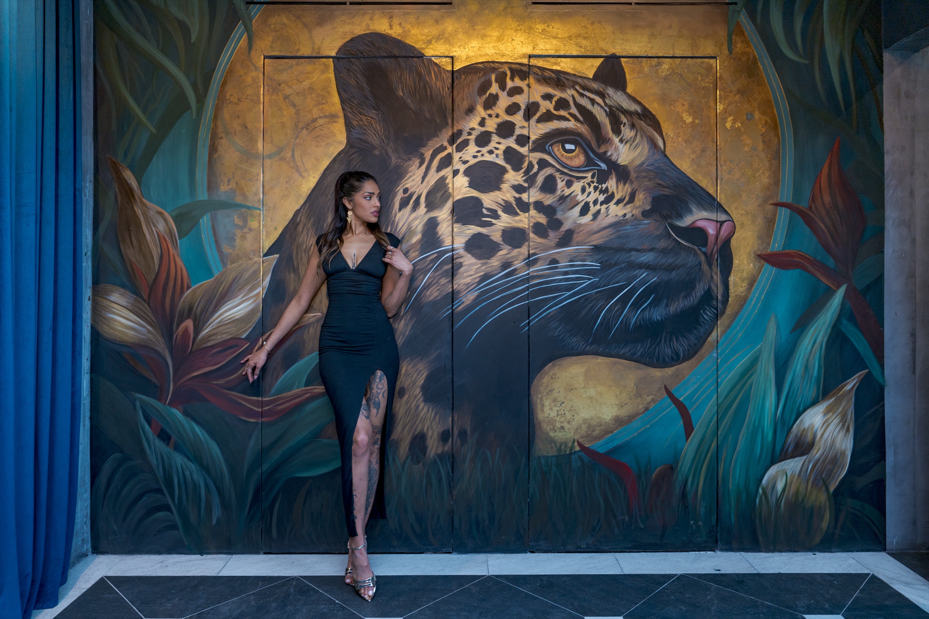 Spirit Animal — a jaguar and golden moon mural framed by tropical leaves, painted by Faith the Creator, Tulum, Mexico