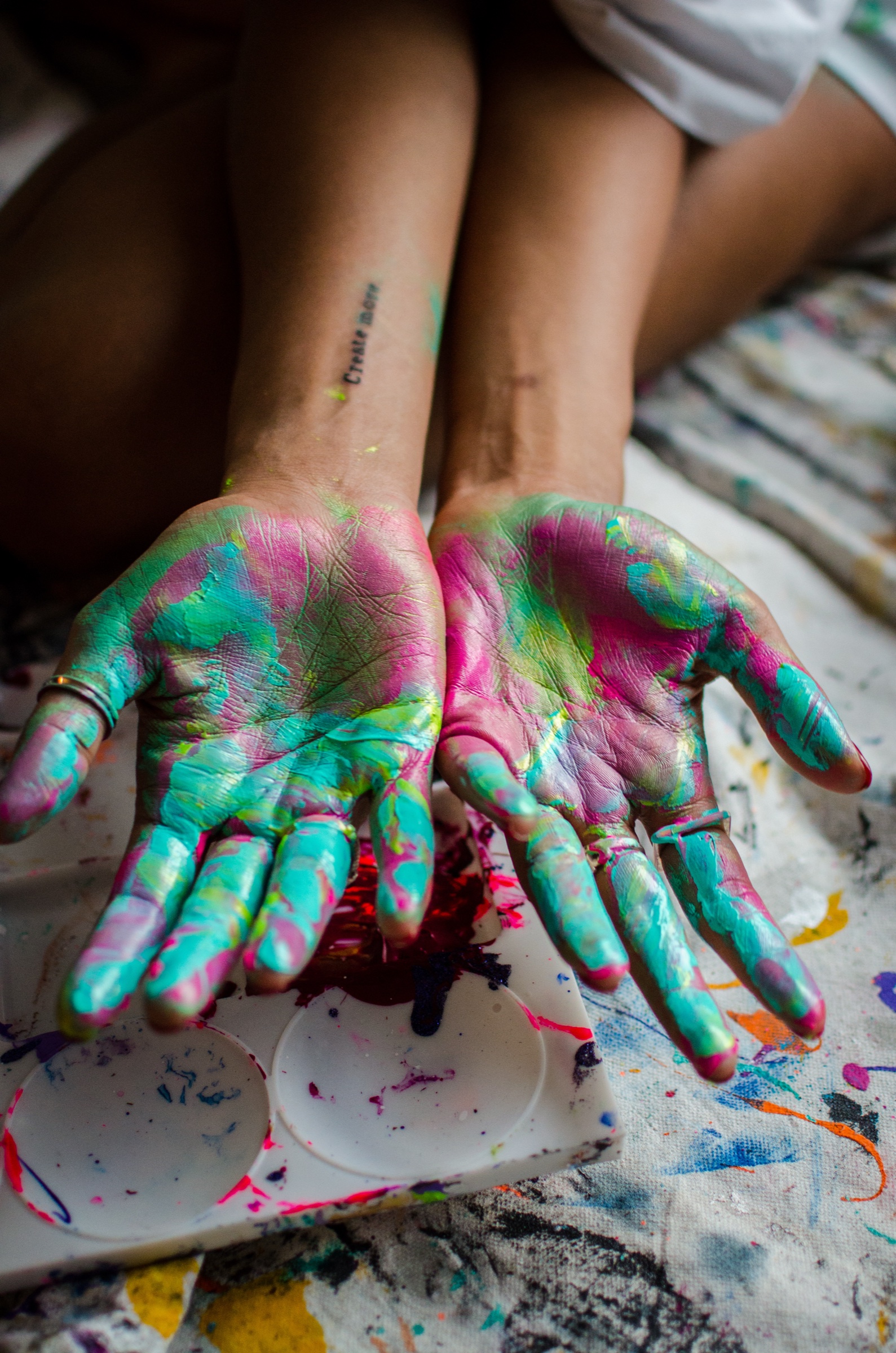 Faith holding out her paint-covered hands